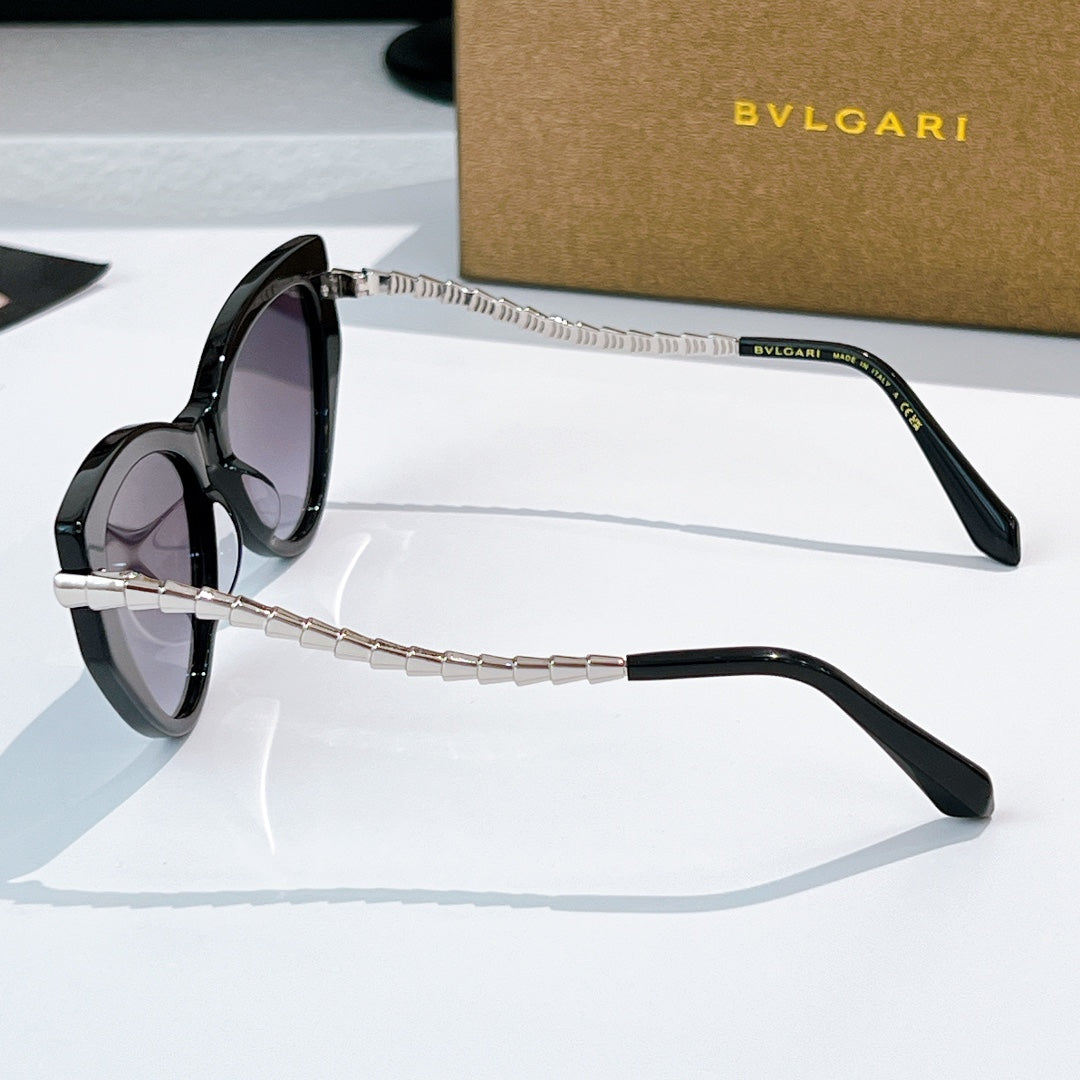 Cat-eye sunglasses with black frames and silver chain arms, tinted lenses