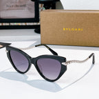Cat-eye sunglasses with black frames, silver chain temples, purple-tinted lenses