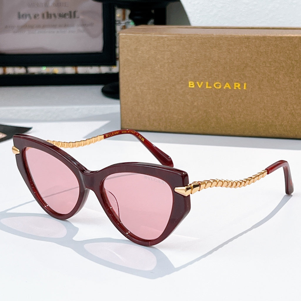 Cat-eye sunglasses with dark red frames, gold chain temples, pink-tinted lenses