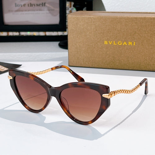 Cat-eye sunglasses with dark tortoise frames, gold chain temples, rose-tinted lenses