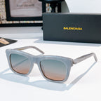 Balenciaga sunglasses with translucent light blue frame and tan tinted lenses