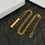 Gold-tone layered chain necklaces with bar pendants and clasp