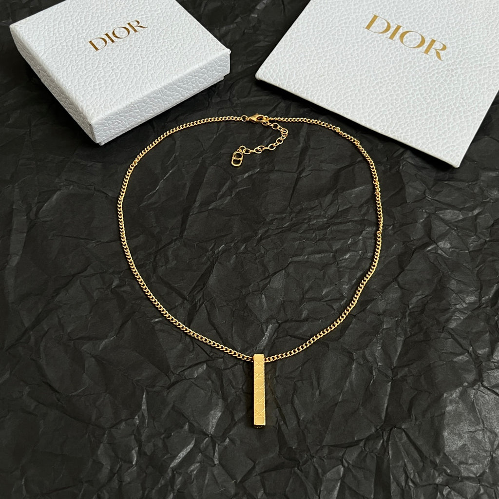 Gold-tone chain necklace with short clasp and vertical bar pendant