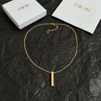 Gold-tone chain necklace with short clasp and vertical bar pendant