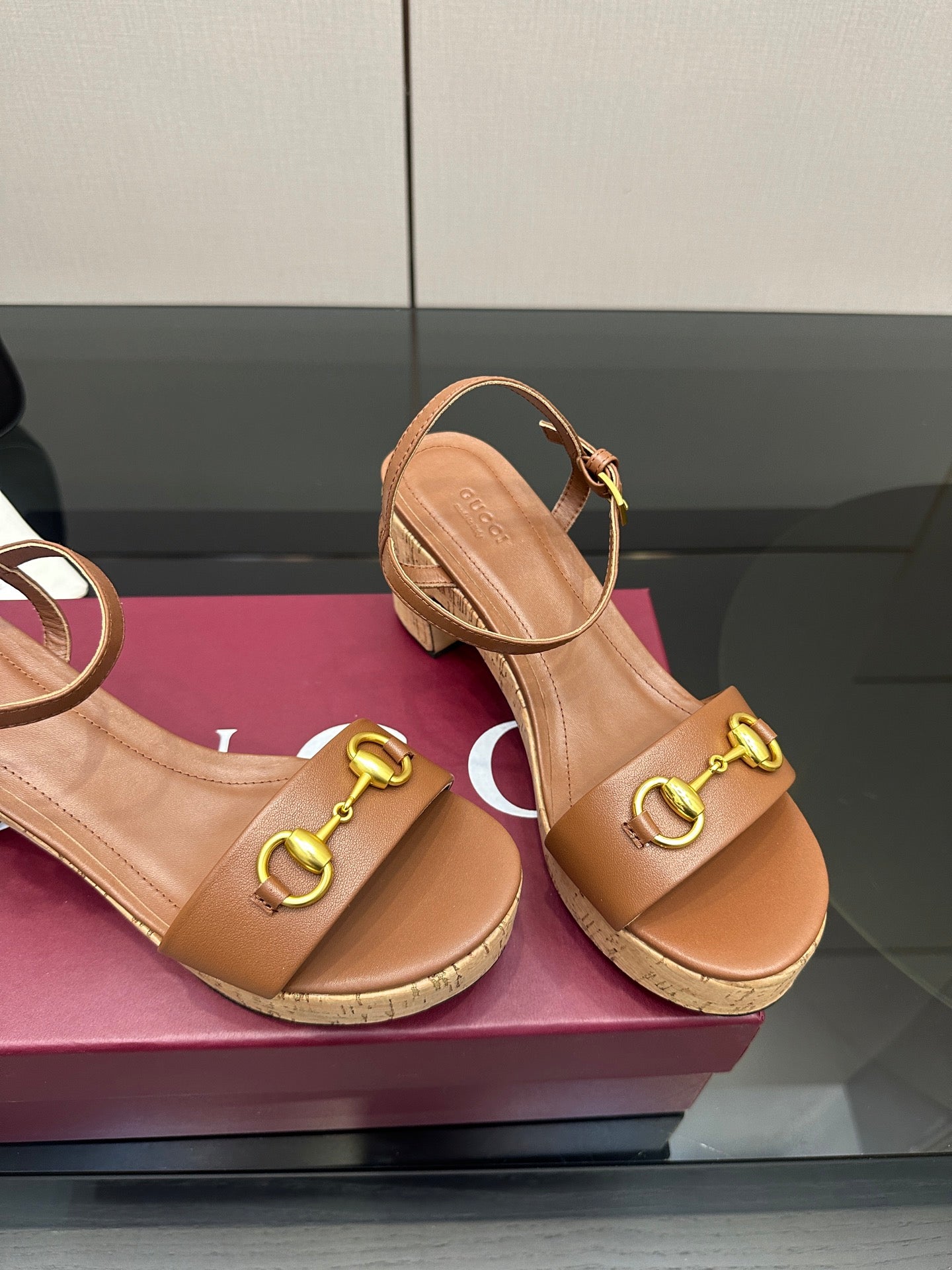 Gucci ladies tan platform sandals, gold buckle hardware and cork-style sole close-up