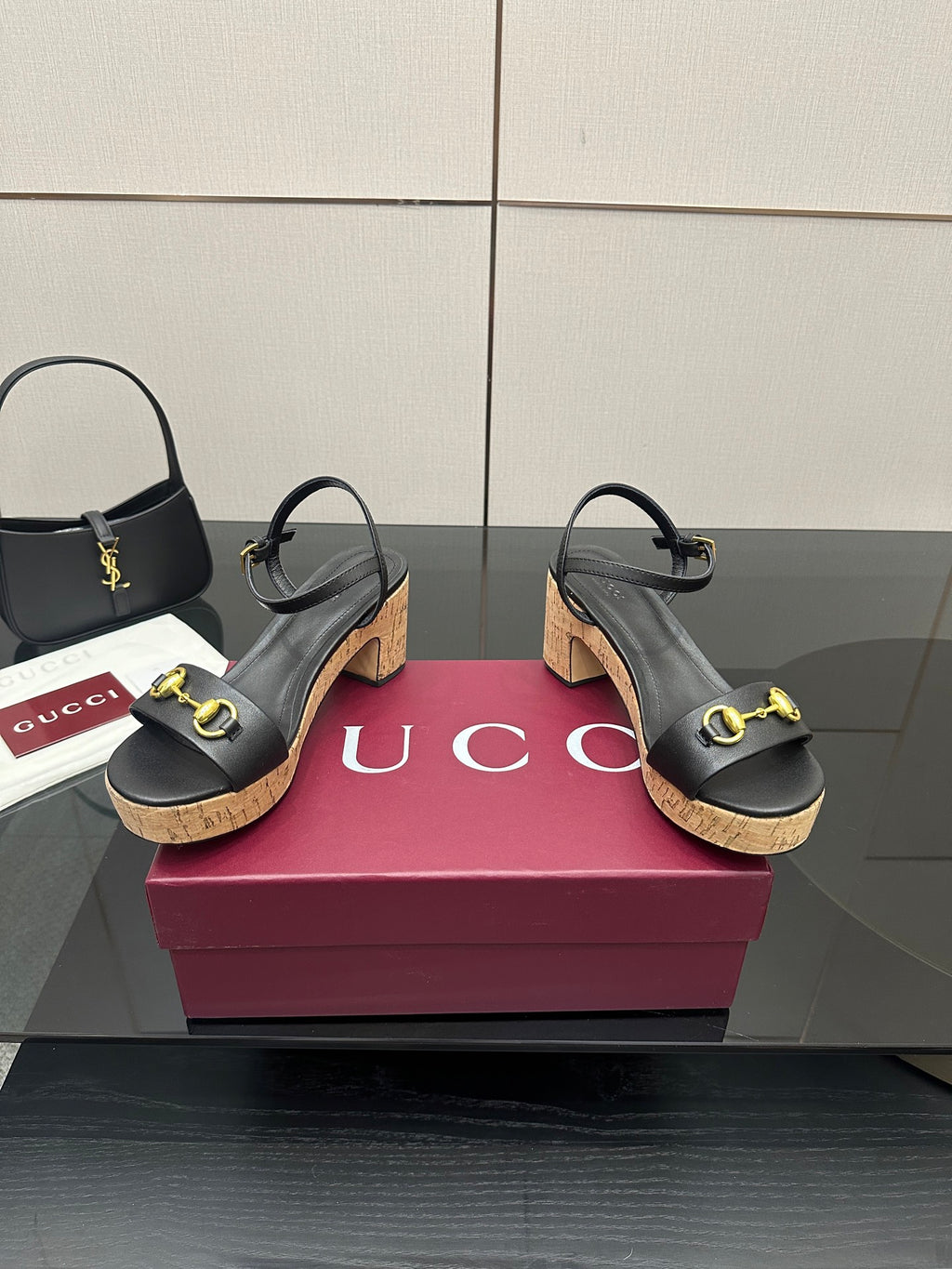 Black strappy sandals with gold buckle accents and cork wedge heel