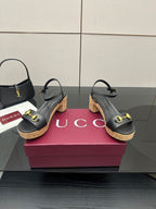 Black strappy sandals with gold buckle accents and cork wedge heel