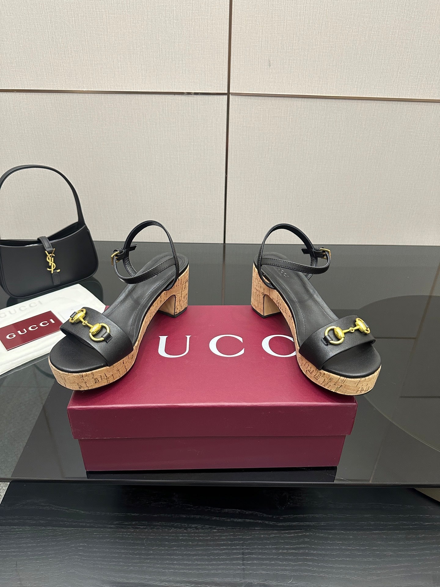Black strappy sandals with gold buckle accents and cork wedge heel