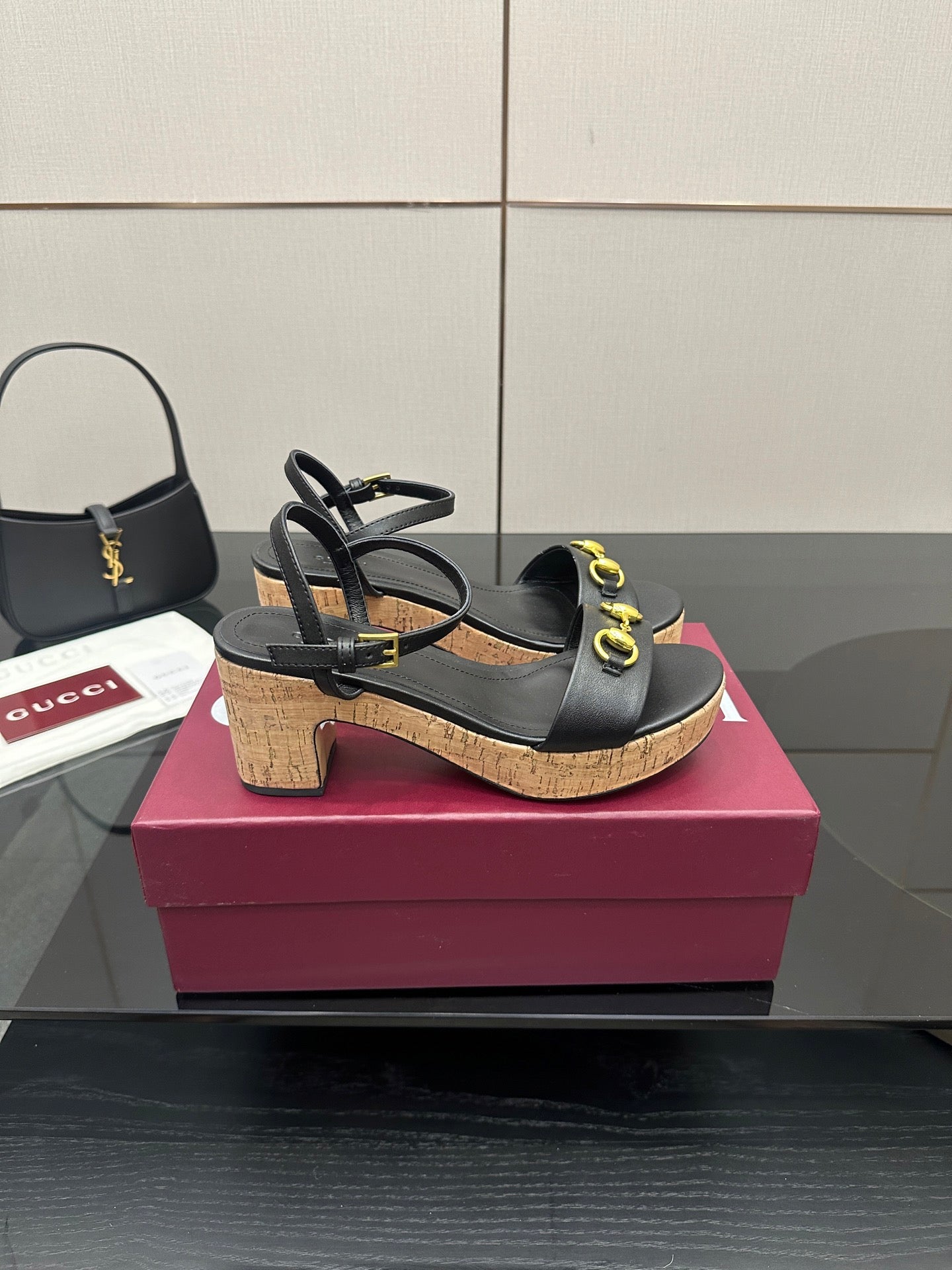 Black strappy platform sandals with gold ring hardware on cork heels