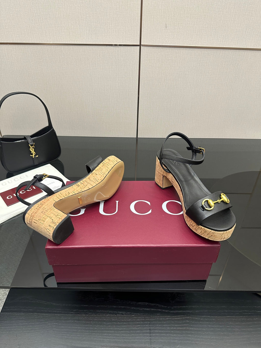 Black platform sandals with gold hardware and cork sole with a stacked heel