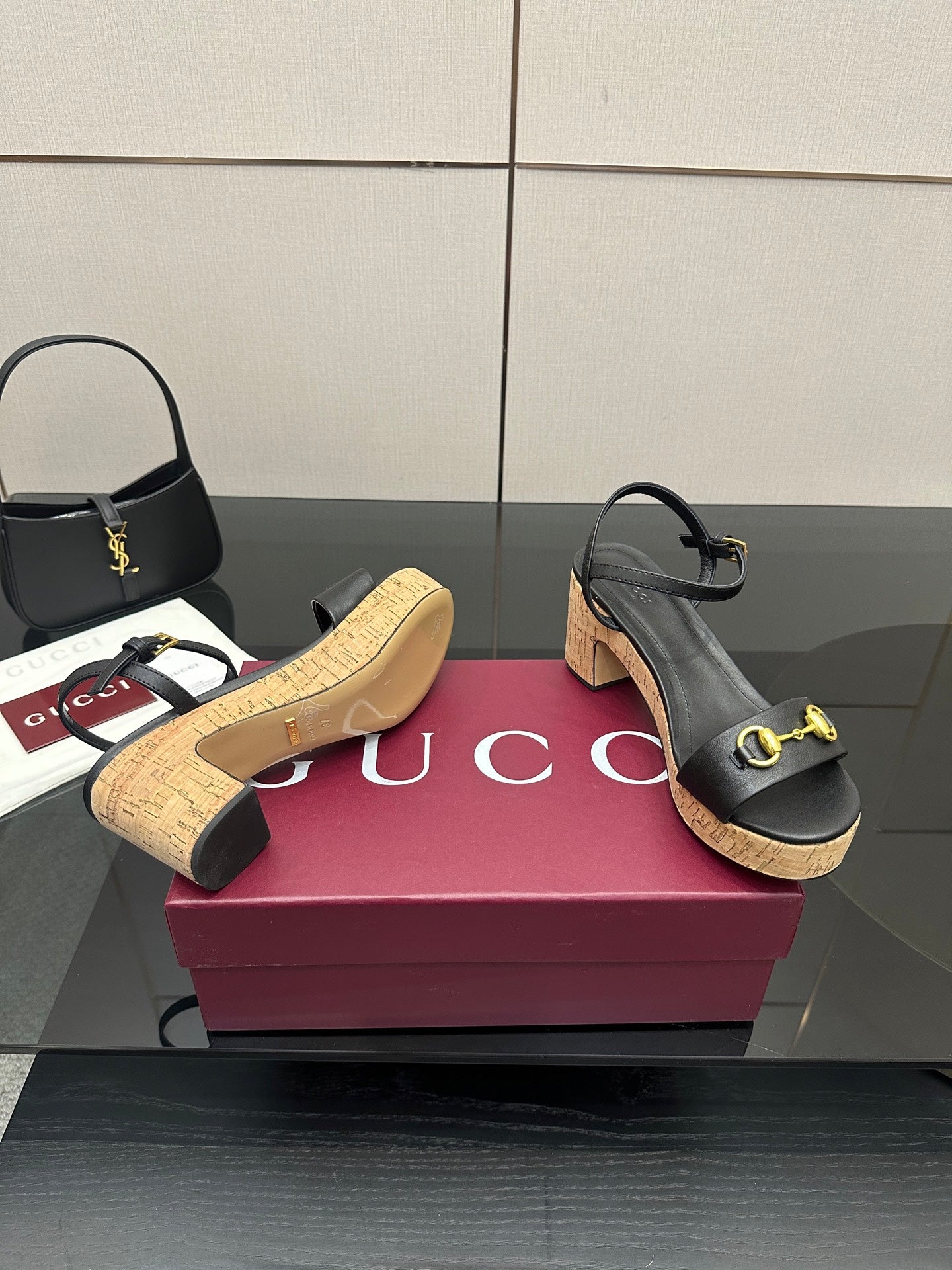Black platform sandals with gold hardware and cork sole with a stacked heel