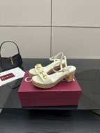 Gucci white heeled sandals with gold horsebit hardware and cork sole