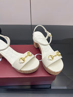 Gucci white heeled slingback sandals close-up with gold horsebit hardware