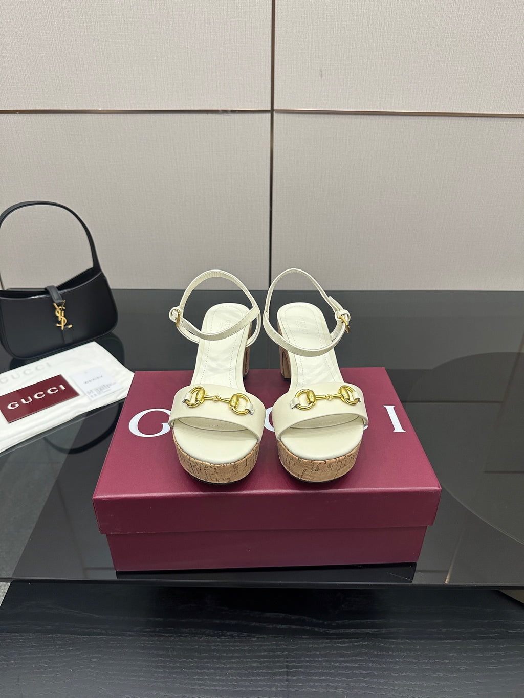 Gucci white heeled sandals with gold buckle detail and cork sole