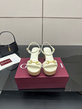 Gucci white heeled sandals with gold buckle detail and cork sole