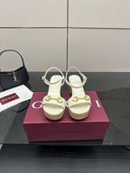 Gucci white heeled sandals with gold buckle detail and cork sole