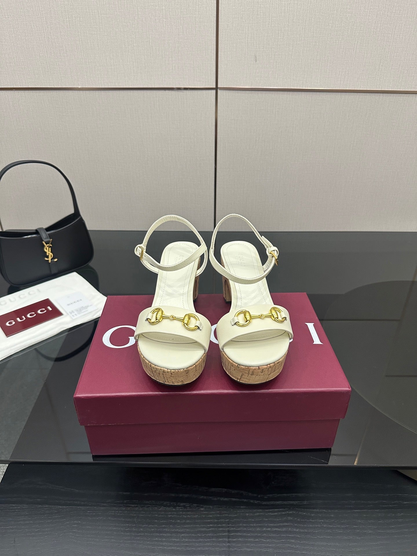 Gucci white heeled sandals with gold buckle detail and cork sole