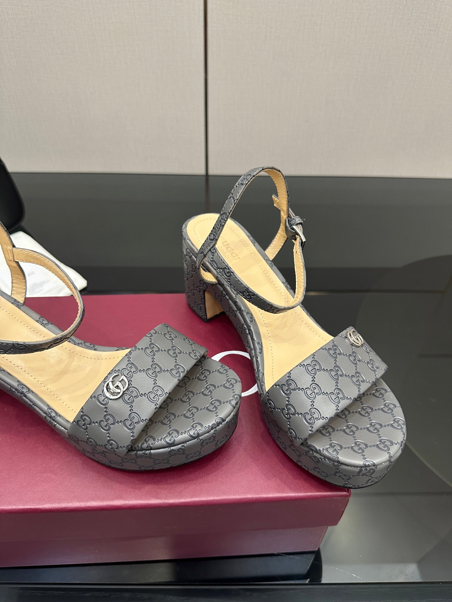 Gucci ladies platform heeled sandals in gray monogram canvas, close-up of straps