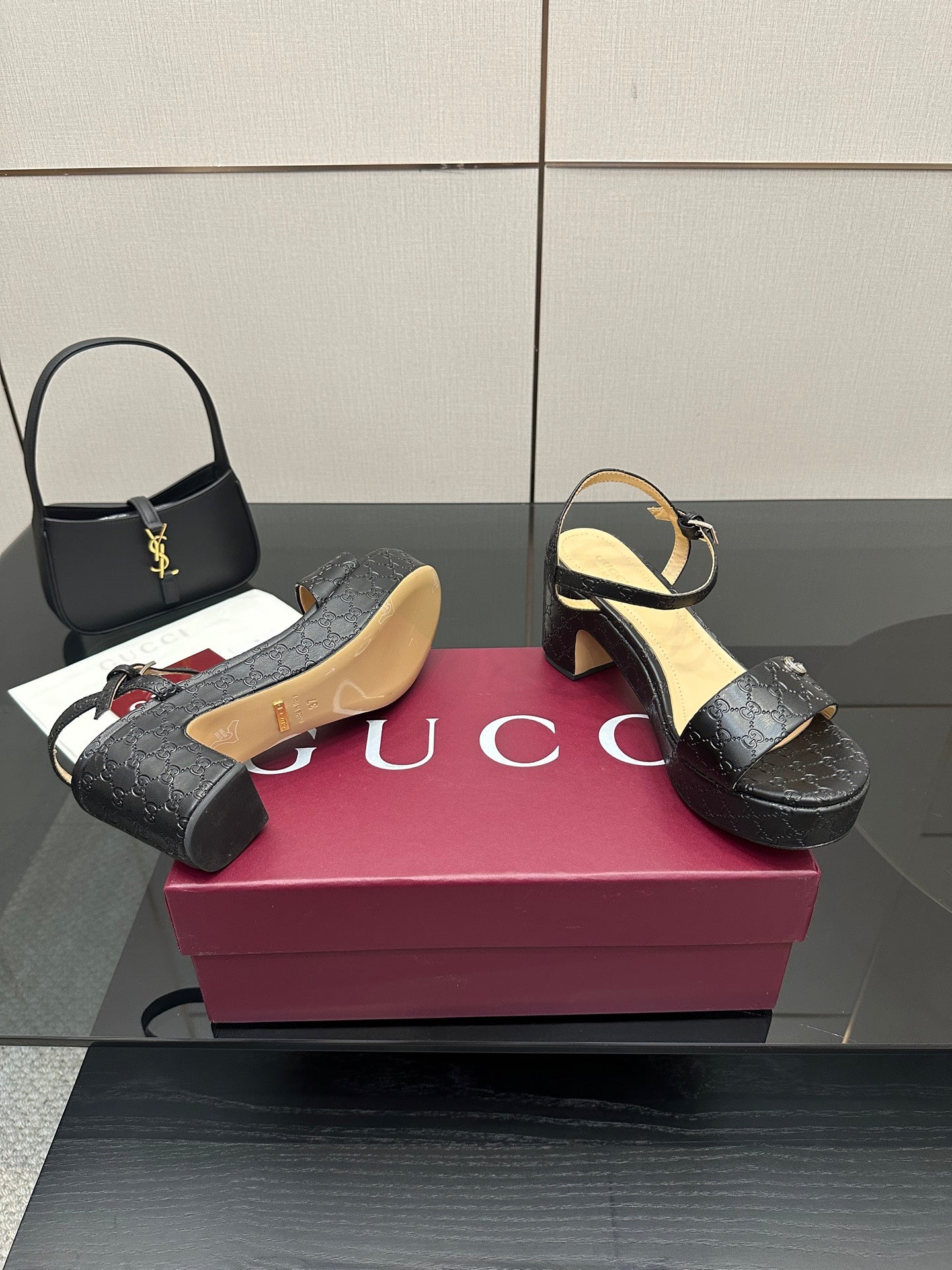 Gucci black platform sandals with ankle strap and GG monogram embossed design