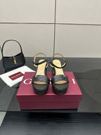 Gucci black platform sandals with ankle strap and textured GG logo pattern