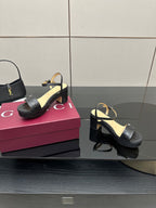 Gucci black platform sandals with ankle strap and GG logo patterned straps