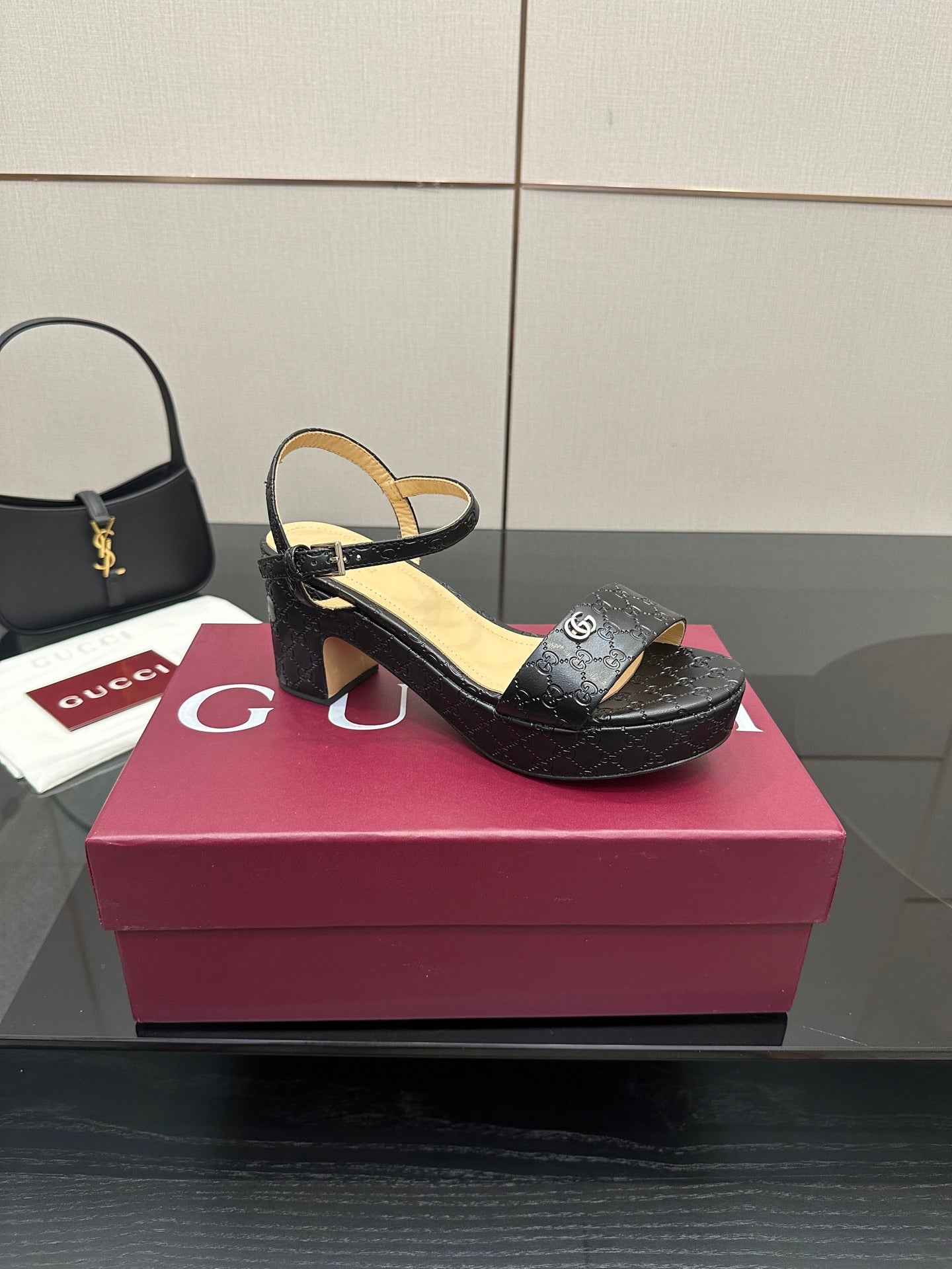 Gucci black heeled slide sandals with ankle strap and GG monogram texture