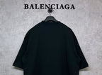 Black T-shirt back view with curved shoulder yoke, hanging on hanger