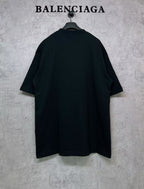 Black T-shirt, back view, hanging on a hanger