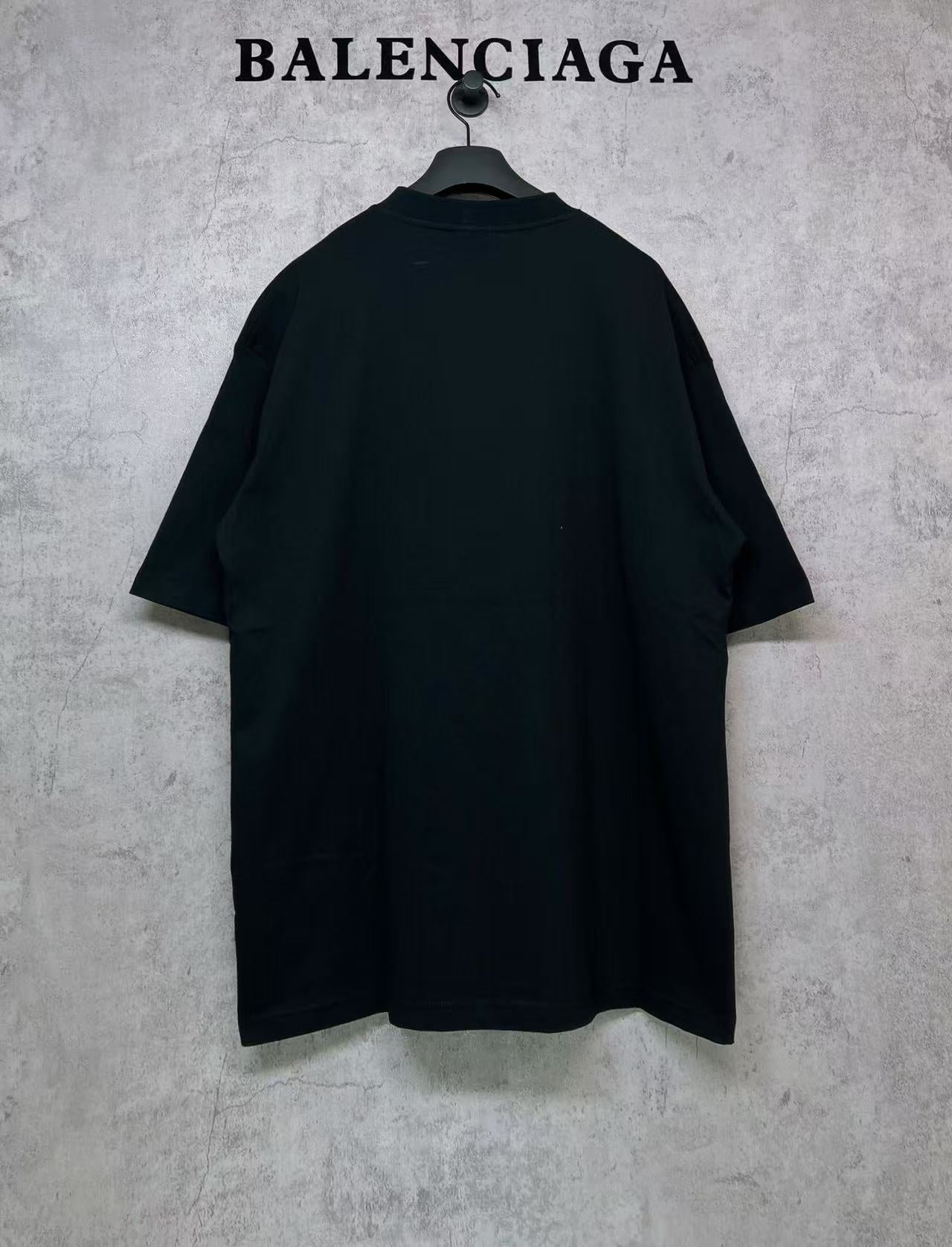 Black T-shirt, back view, hanging on a hanger