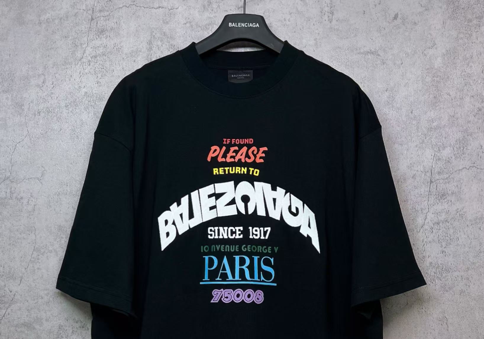 Black T-shirt front view with graphic print centered on chest