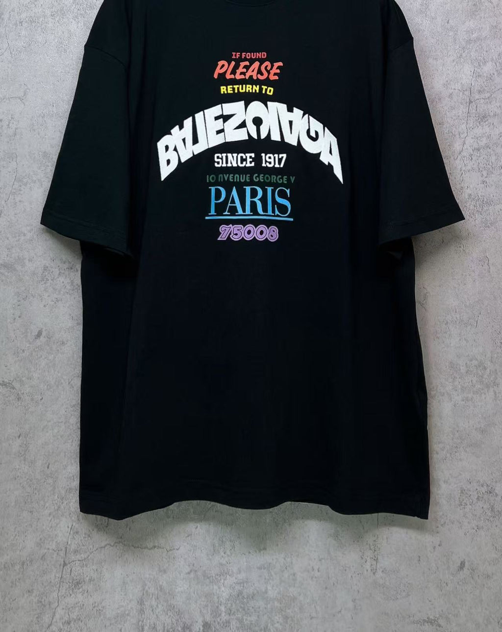 Black T-shirt front view with center graphic print and “PARIS”