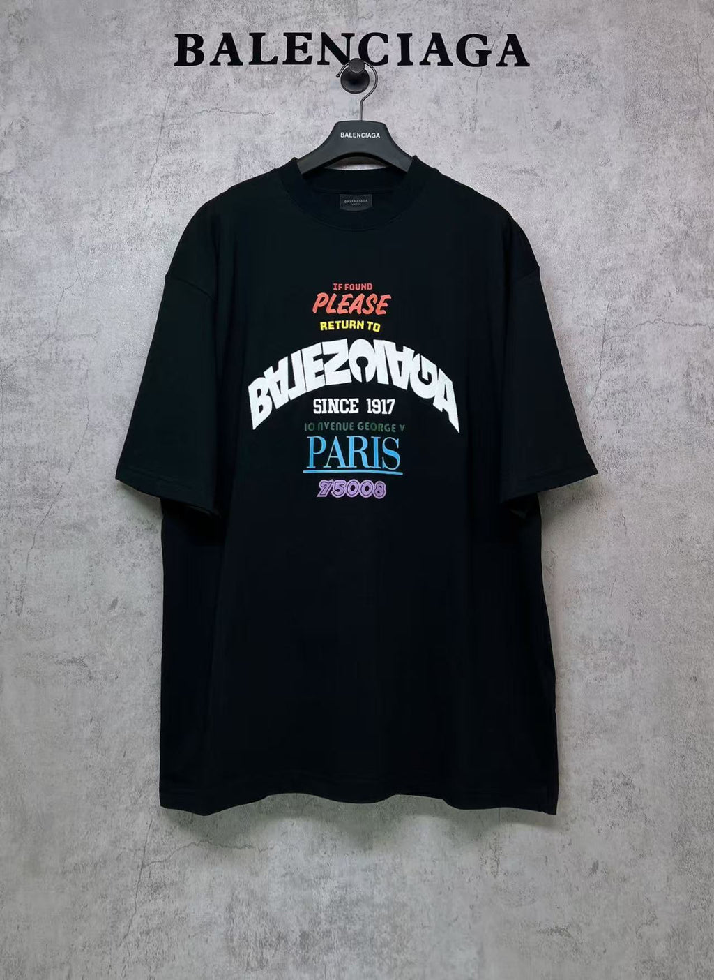 Black T-shirt with large front graphic text and logo on chest
