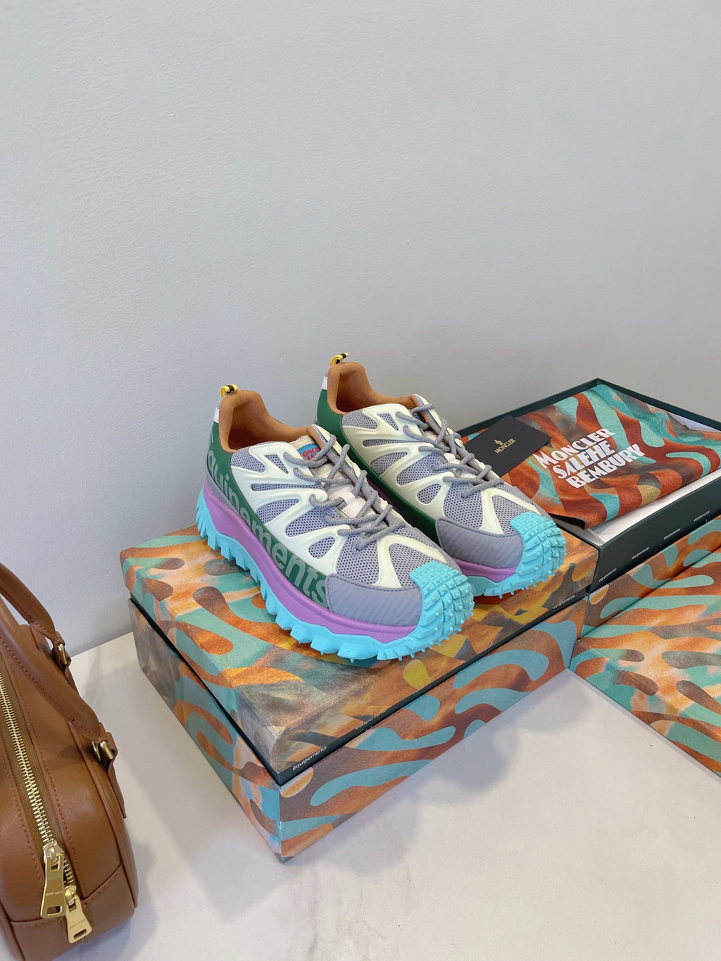 Moncler lace-up sneakers in white-gray with teal and purple accents on thick sole