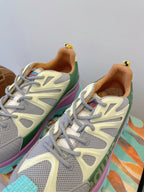 Moncler close-up sneakers: white-gray mesh uppers, green side panel, purple trim, laces