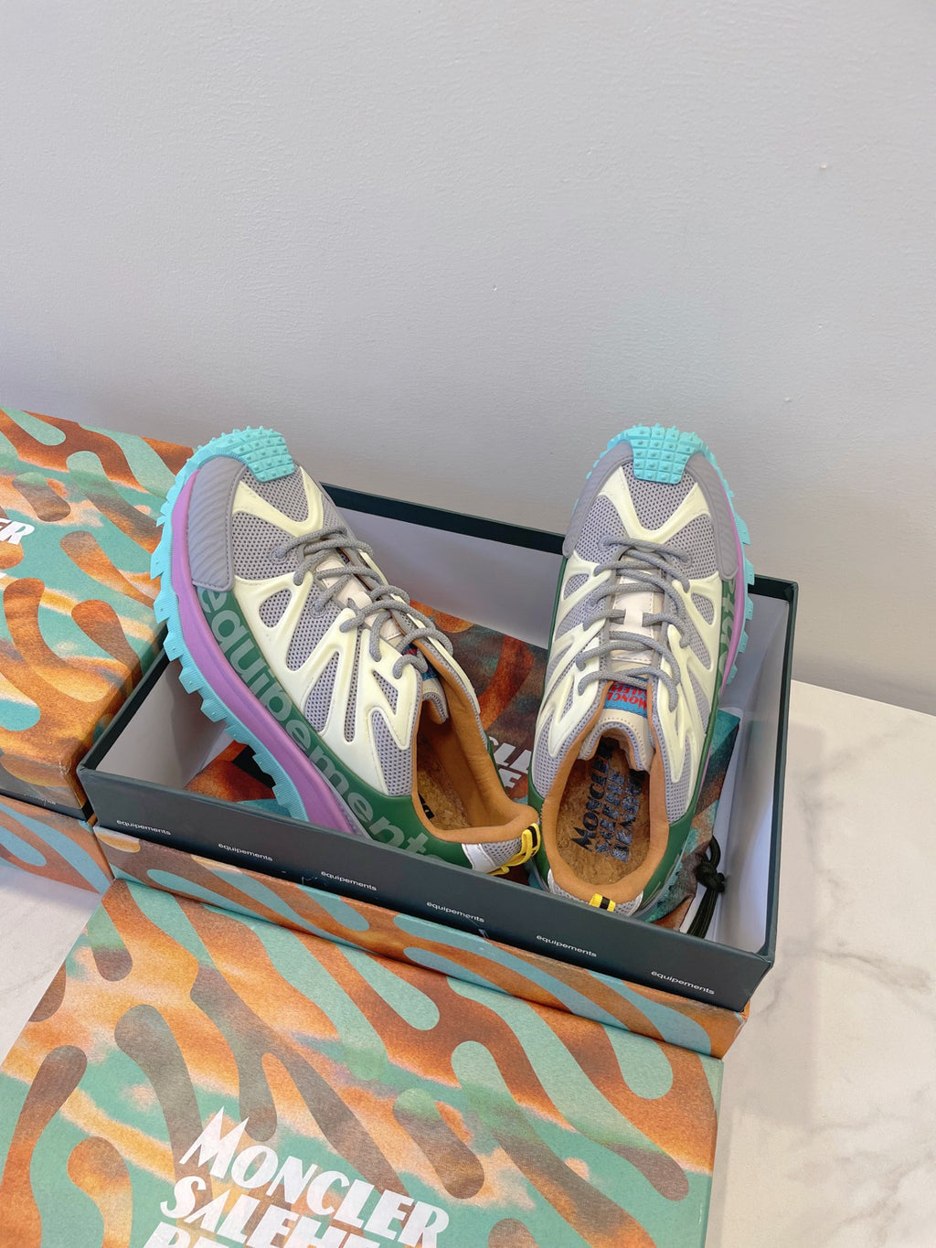 Moncler sneakers pair view: white-gray mesh, purple side stripe, turquoise sole tread