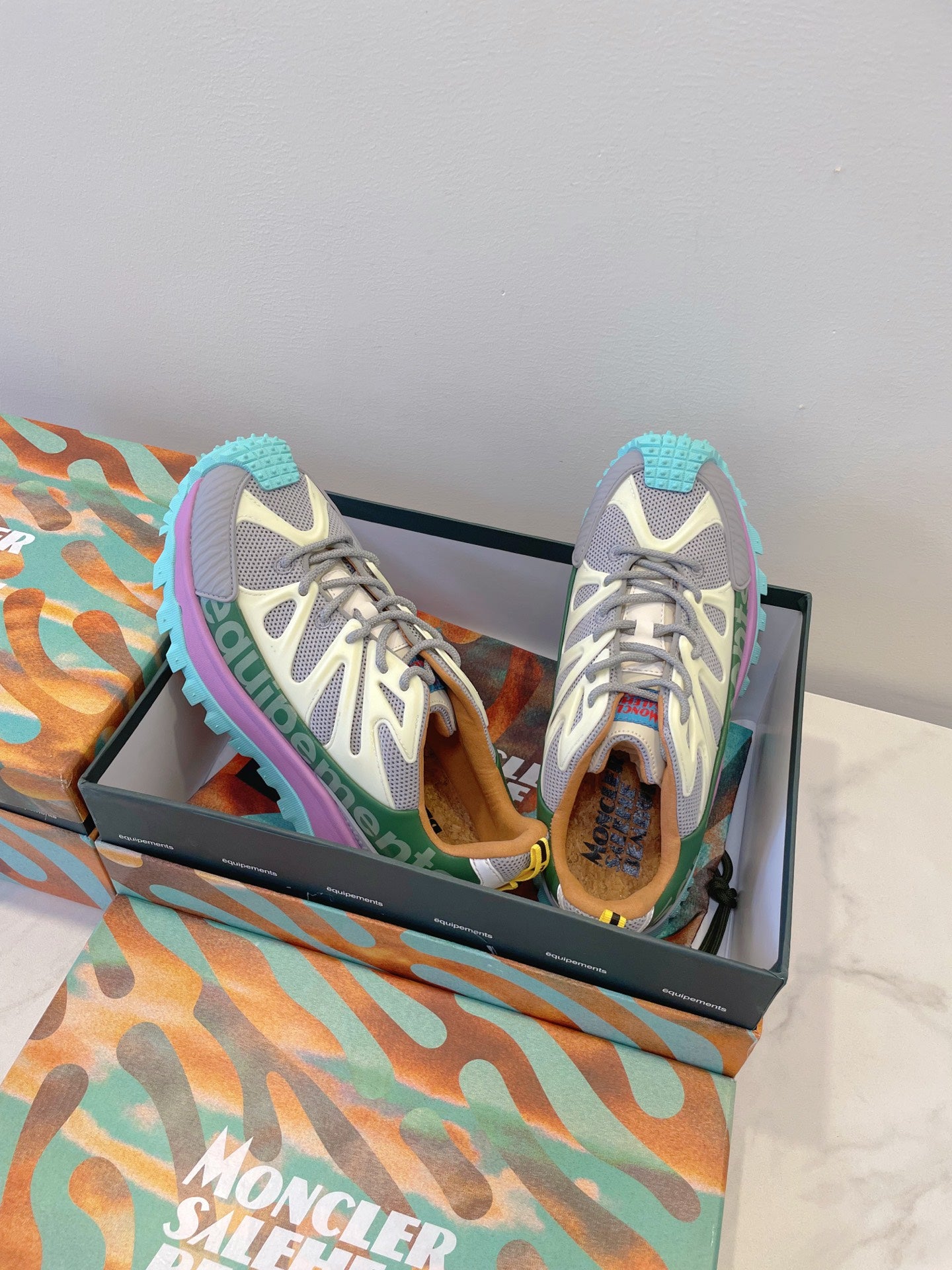 Moncler sneakers pair view: white-gray mesh, purple side stripe, turquoise sole tread