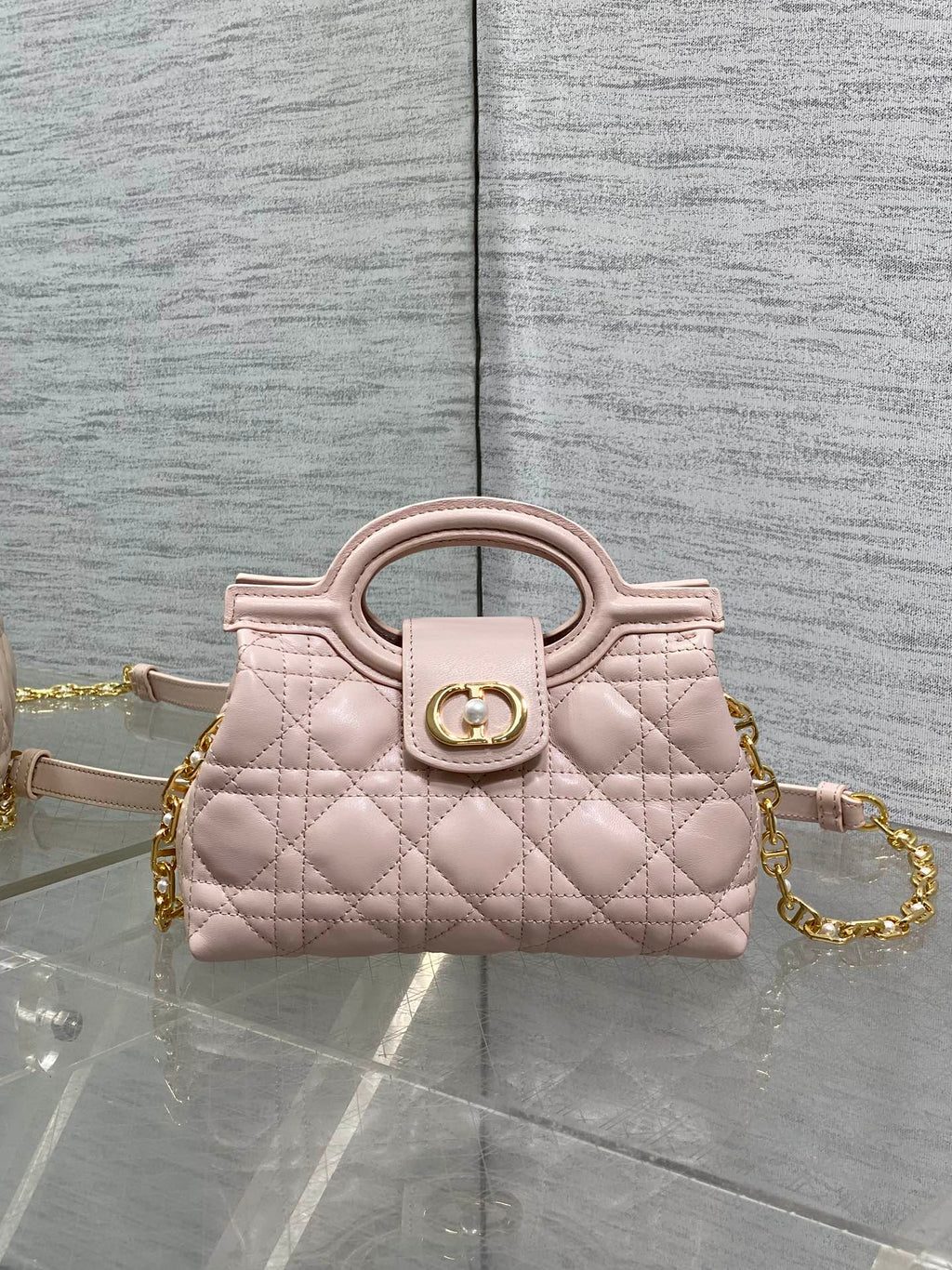 Dior quilted mini handbag in pale pink with gold chain and top handle