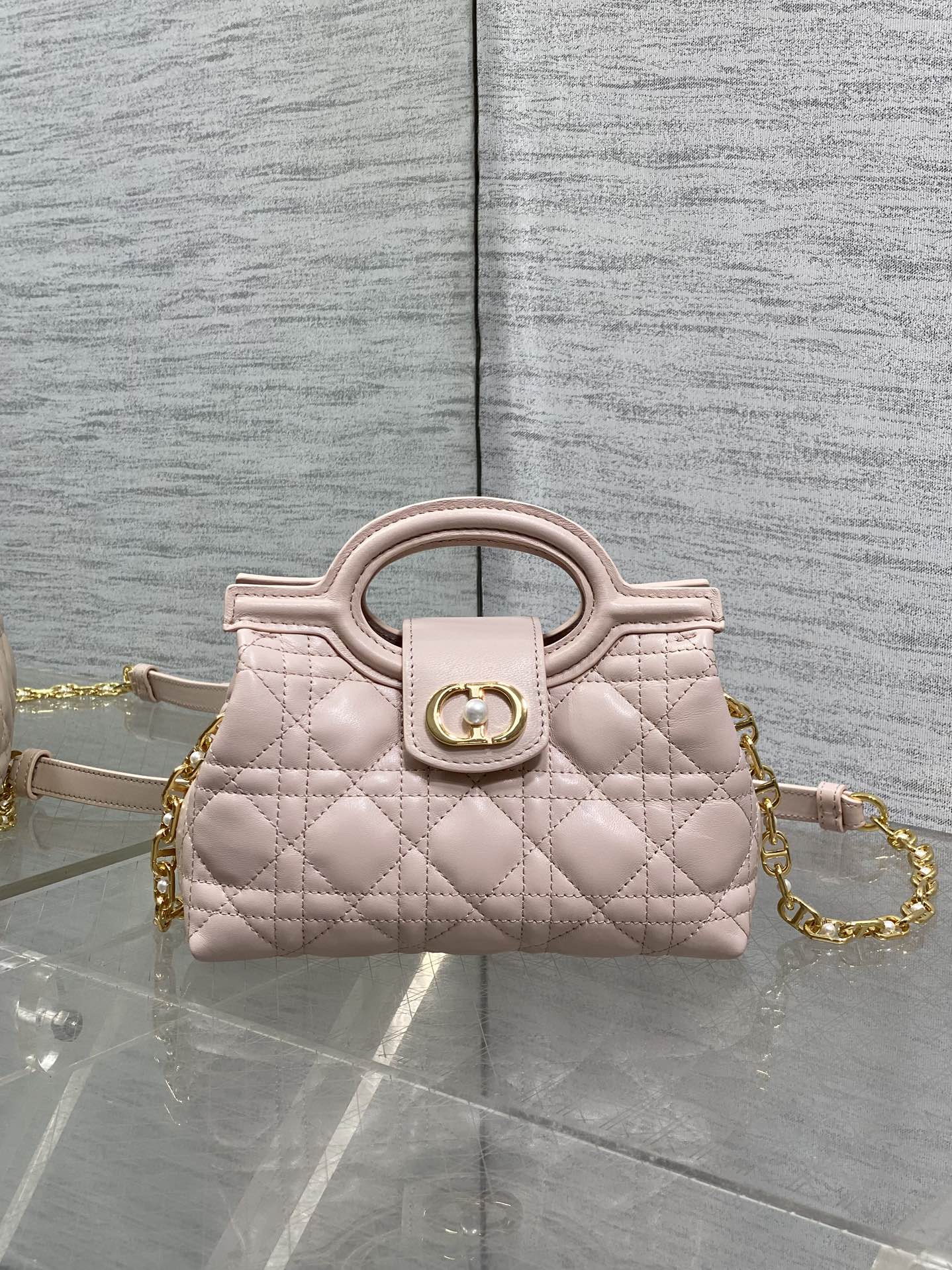 Dior quilted mini handbag in pale pink with gold chain and top handle