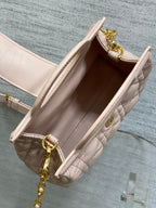 Dior pale pink handbag with open top, quilted interior, and gold-tone hardware
