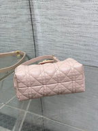 Dior quilted mini handbag in pale pink with rounded top and rolled handle