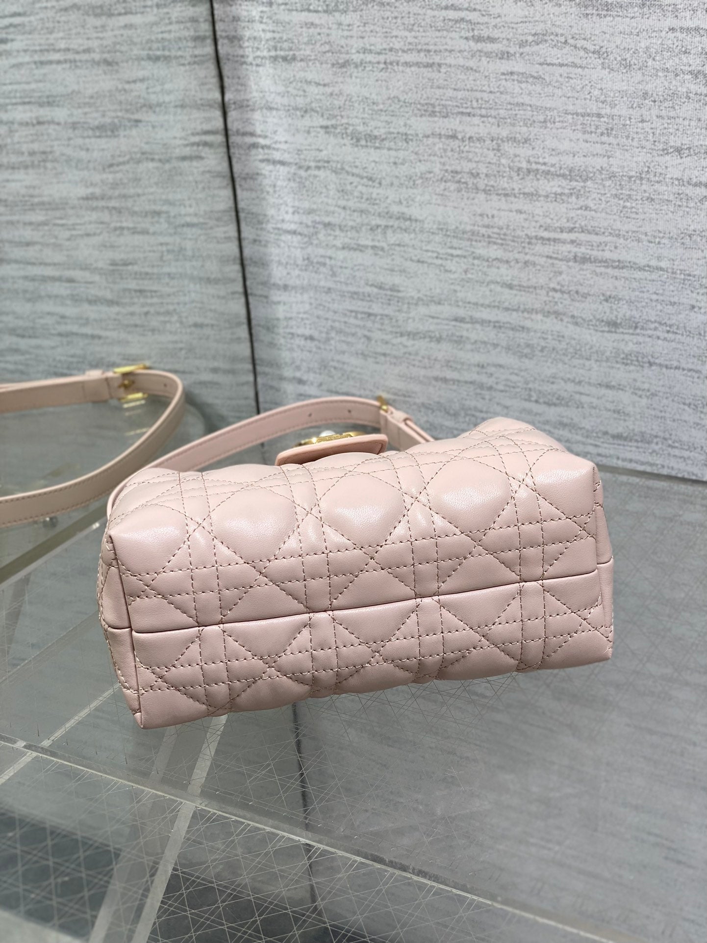 Dior quilted mini handbag in pale pink with rounded top and rolled handle