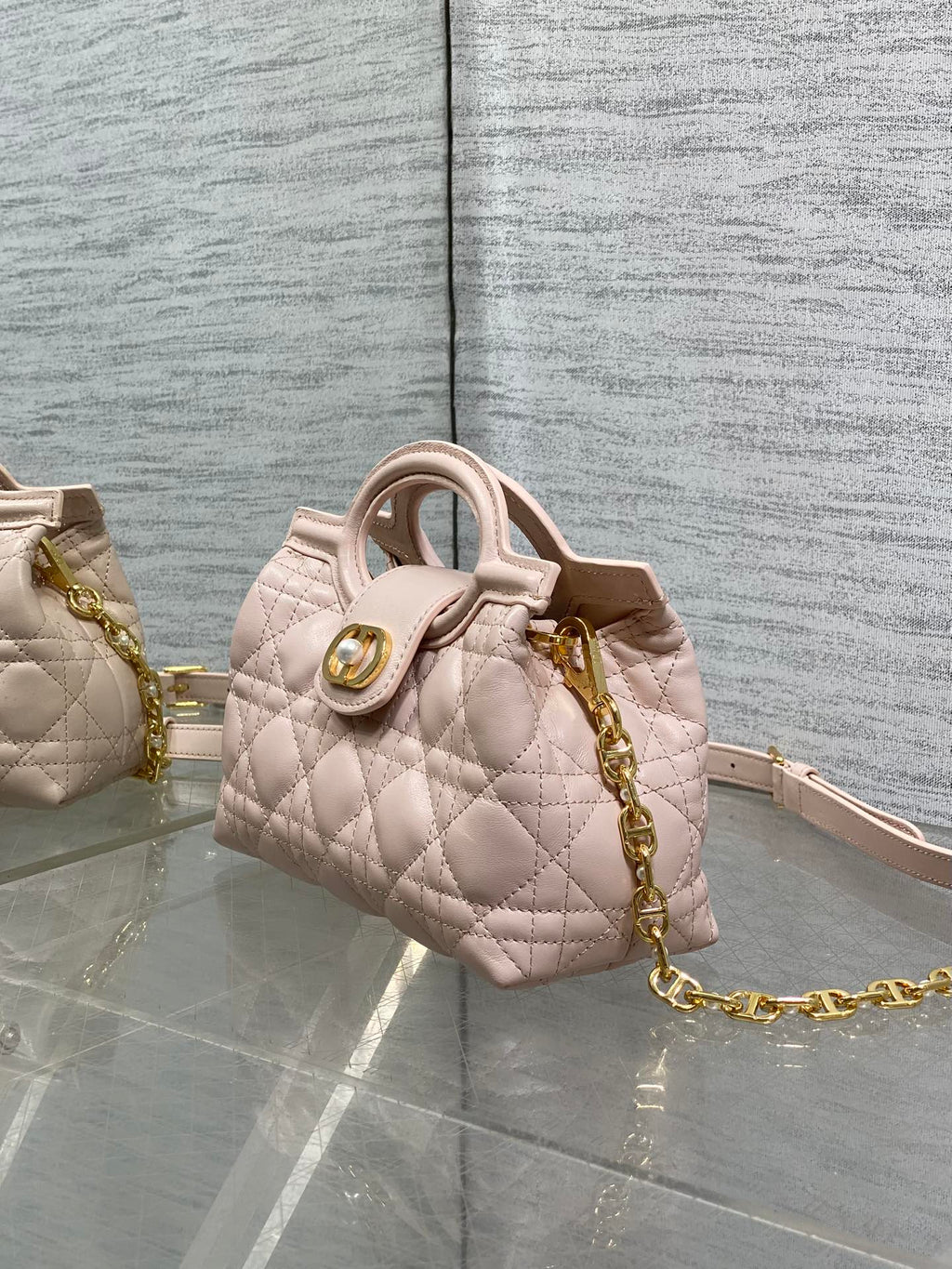 Dior quilted mini handbag in pale pink with gold chain and top handle
