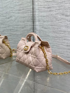 Dior quilted mini handbag in pale pink with gold chain and top handle