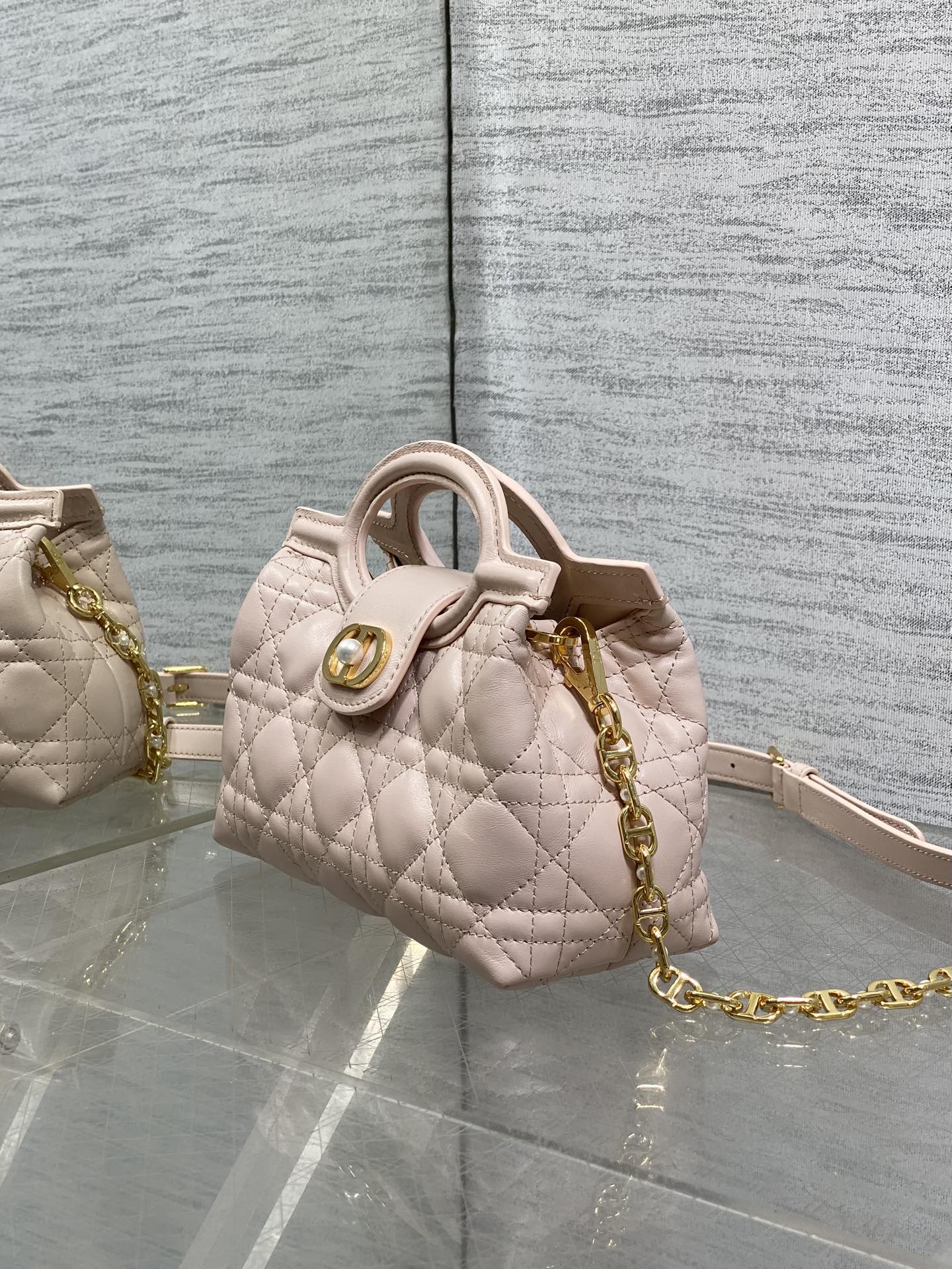 Dior quilted mini handbag in pale pink with gold chain and top handle