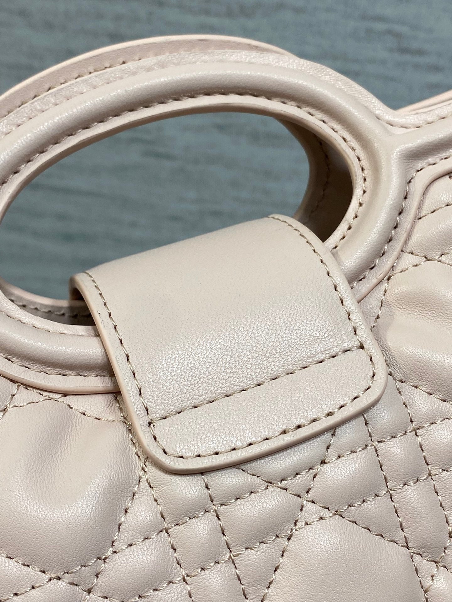 Dior pale pink leather handle with quilted stitching and top strap