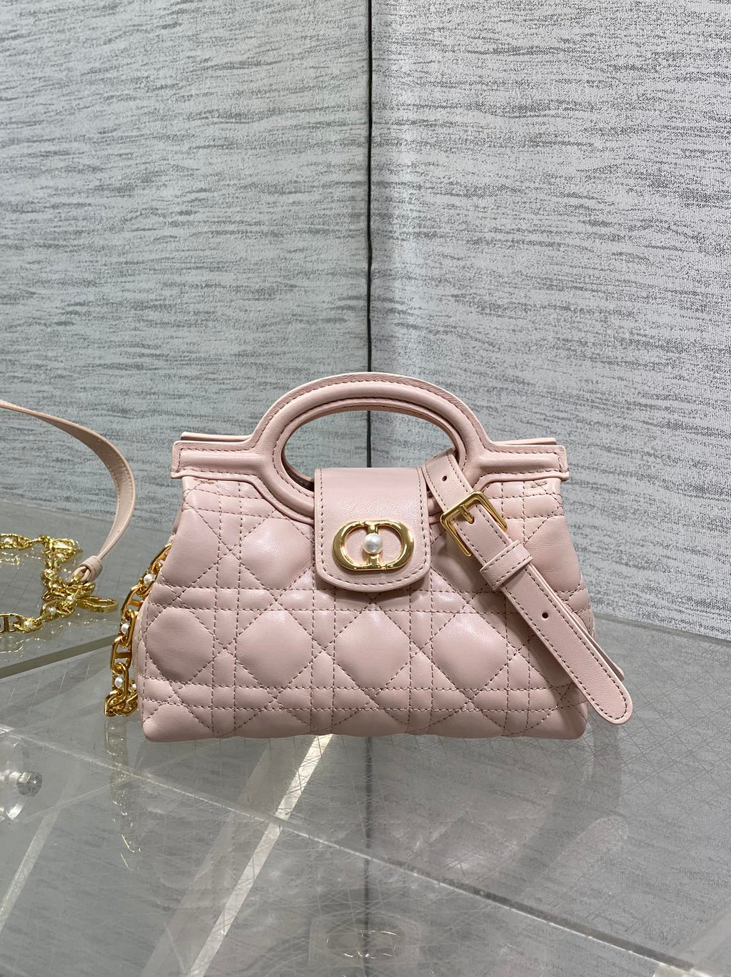 Dior quilted mini handbag in pale pink with gold-tone clasp and wrist strap