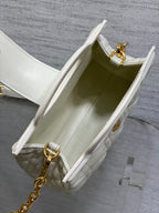 Dior quilted mini handbag interior view with open top and gold clasp hardware