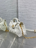 Dior quilted mini handbag with top handle, gold chain strap, and matching side detail