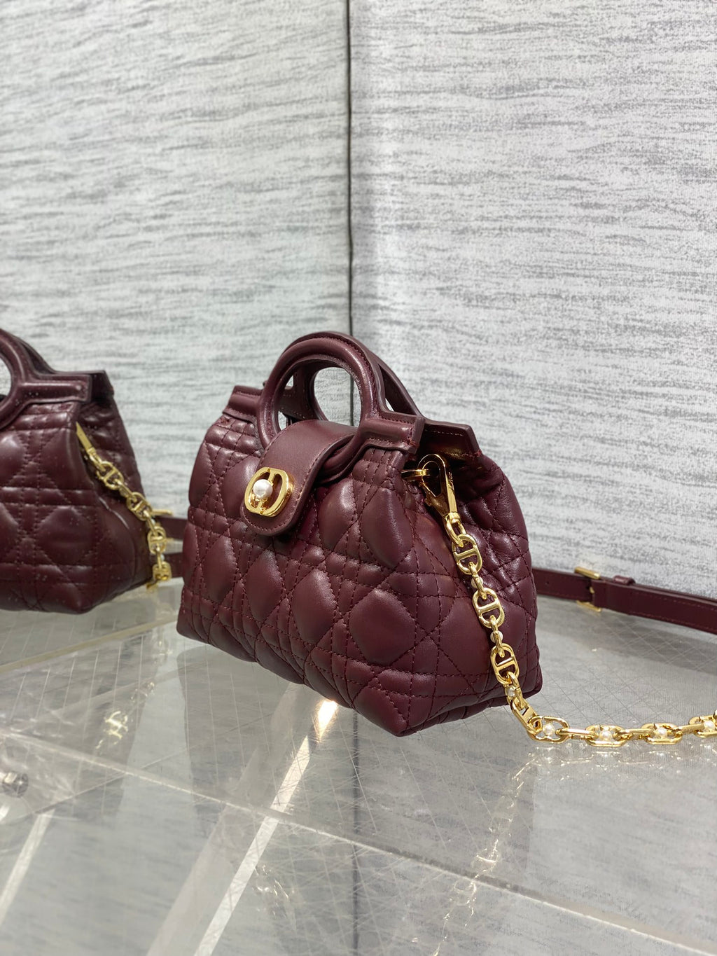 Dior maroon quilted mini handbag with shoulder strap and gold-tone chain hardware