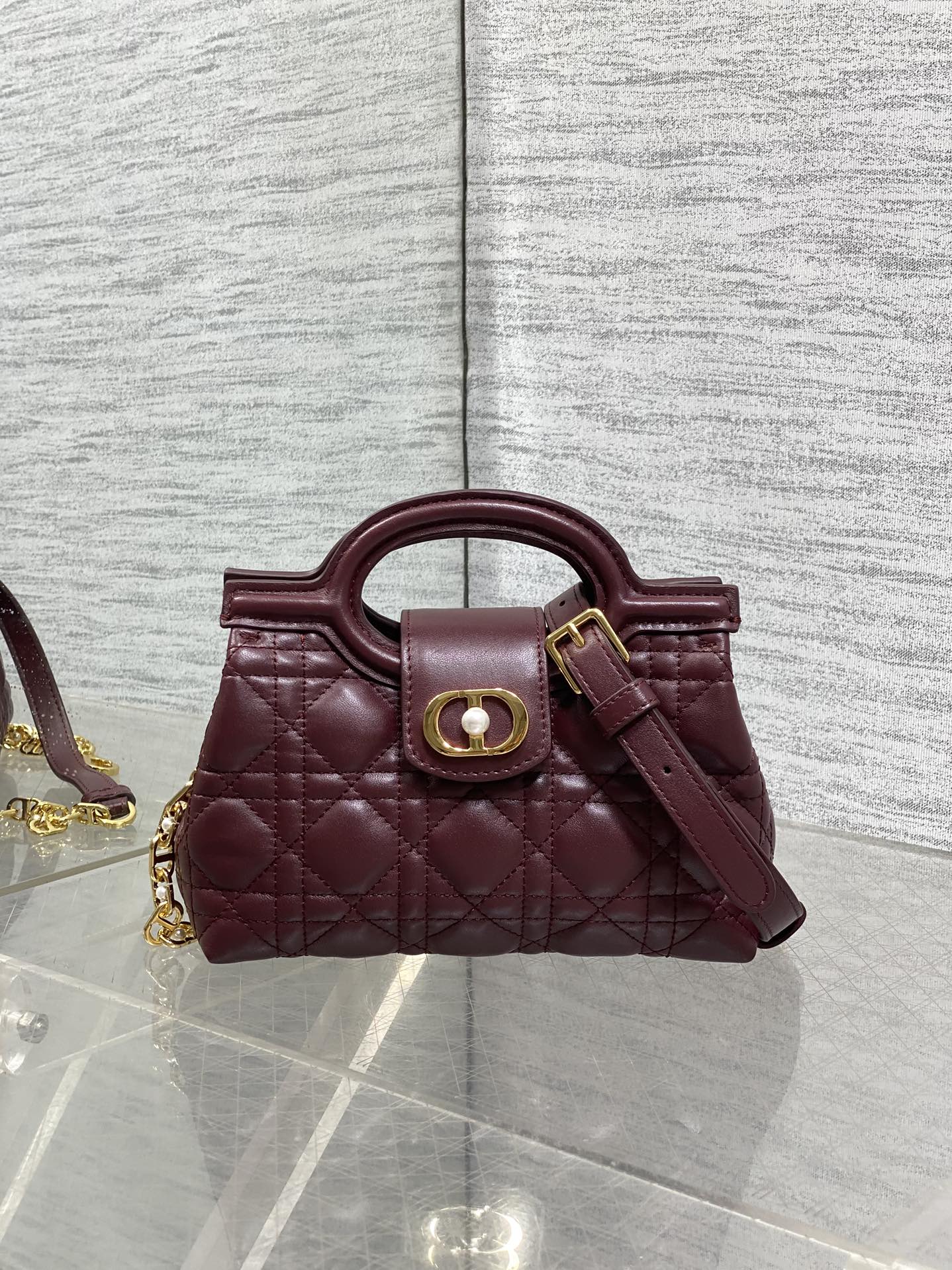 Dior quilted mini handbag in maroon leather with top handle and gold-tone hardware